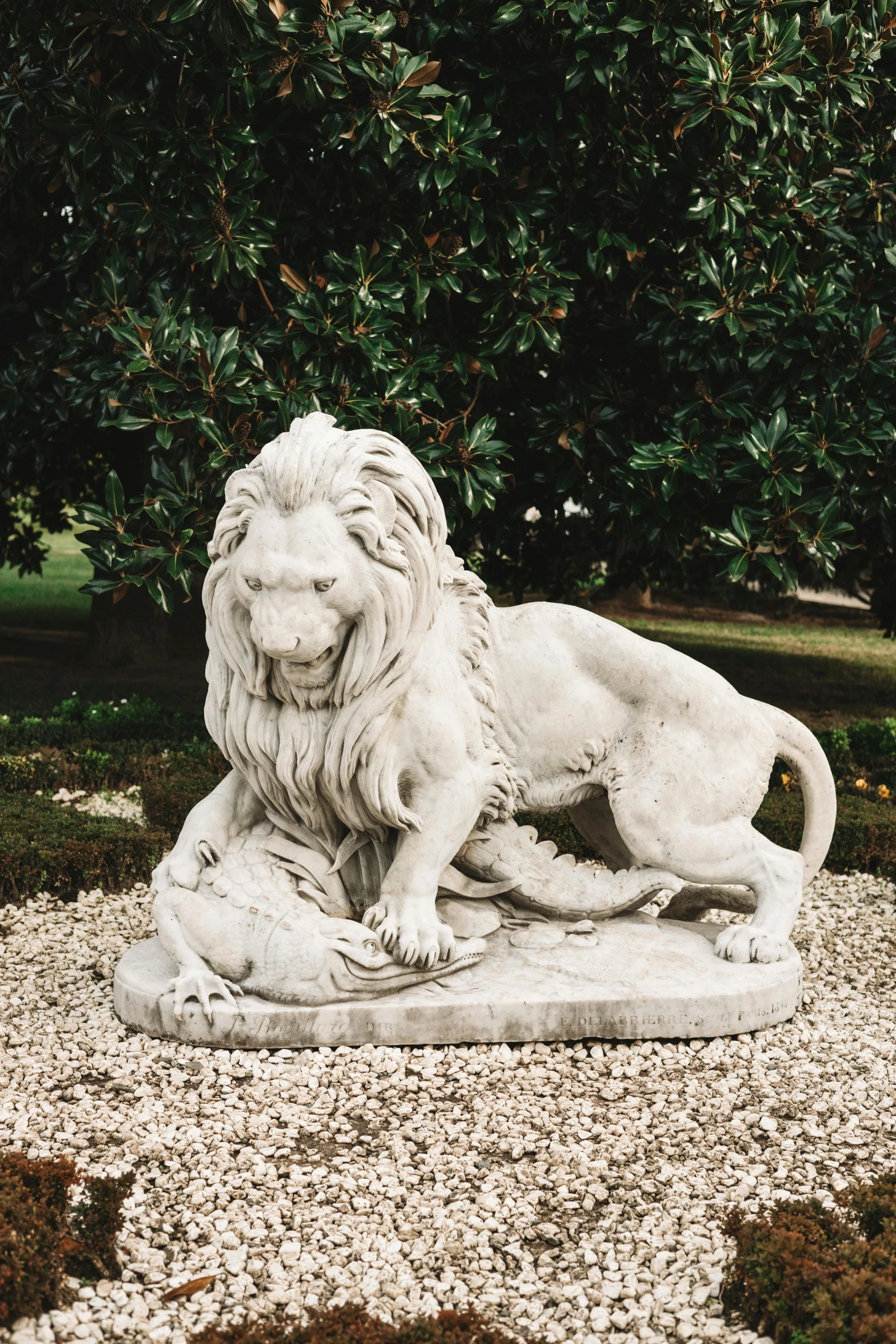 white statue with lion lying down and looking at the pographer