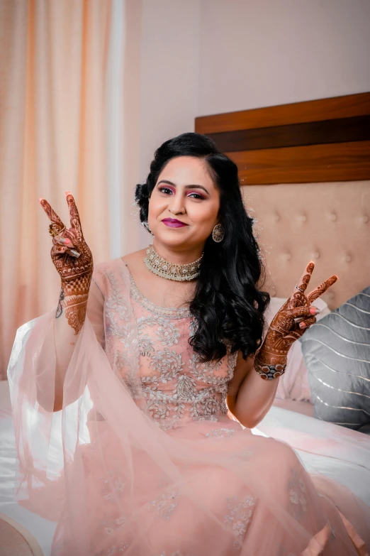 woman sitting on a bed with her hands painted like peace signs