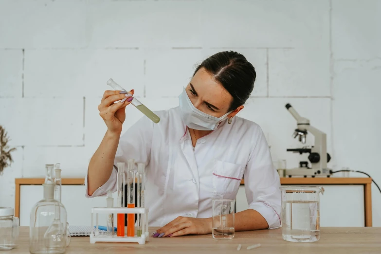 a person wearing a face mask while making a substance