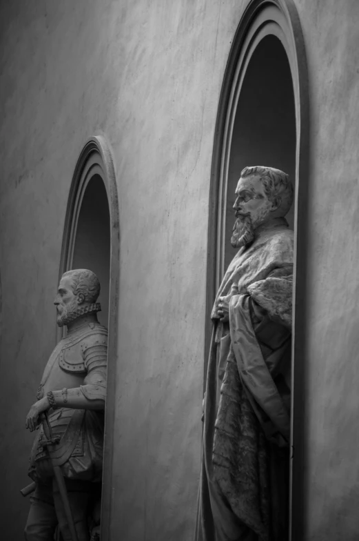 statues of old people standing in a window