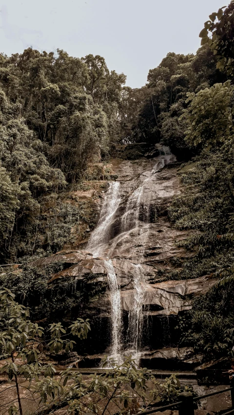 two waterfalls are falling down to the ground