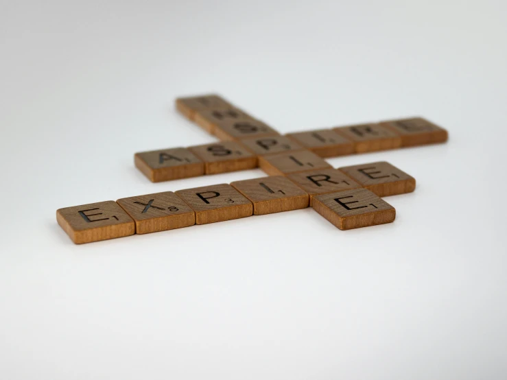 the small wooden scrabble game is on a table