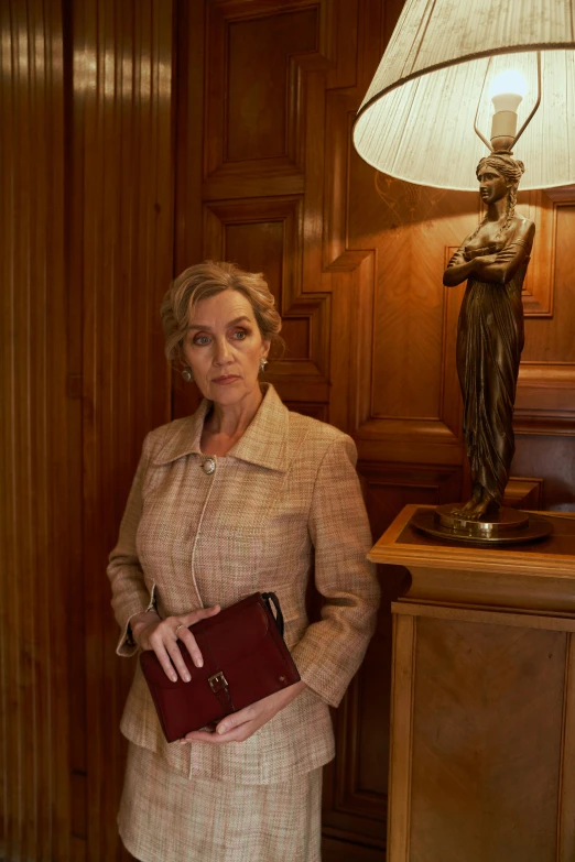 a woman standing in a room near a lamp