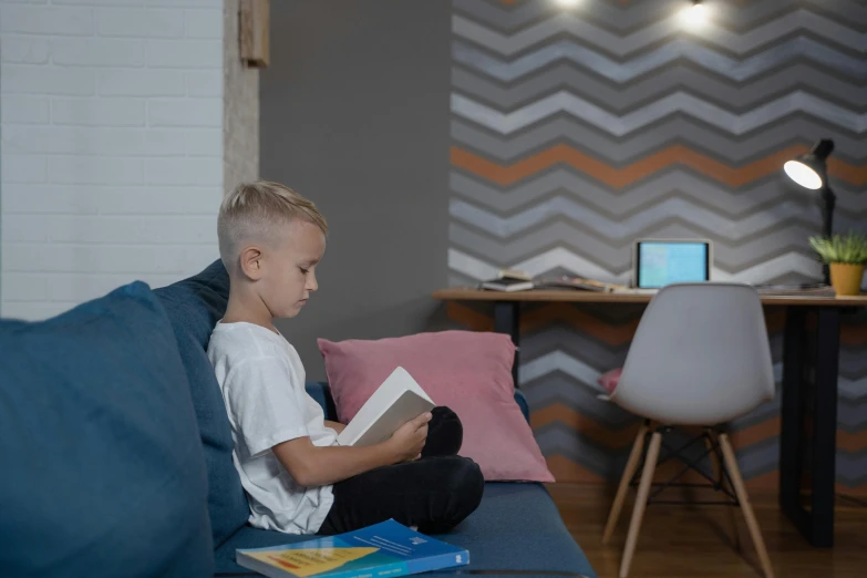  reading book on couch in living area