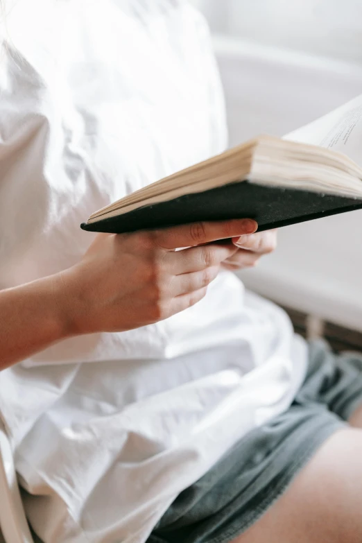 there is a person sitting down reading a book