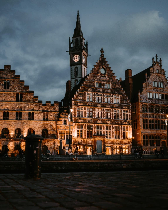 a large clock tower is near the old buildings