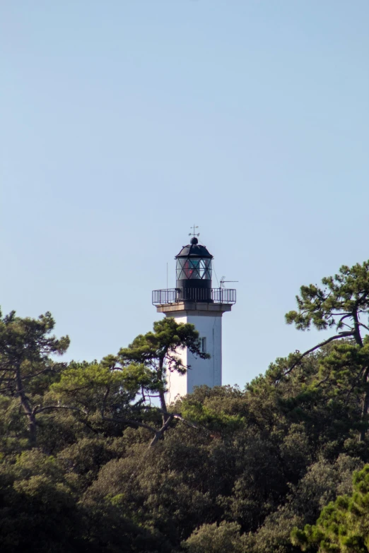 there is a tall light tower with a clock on top