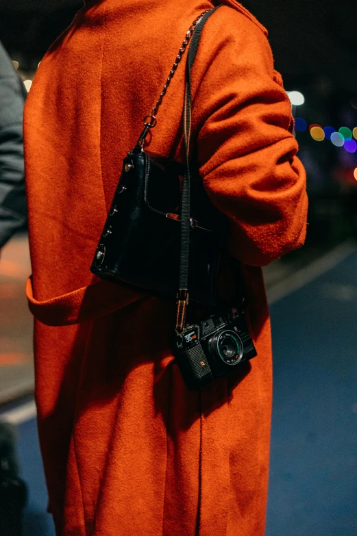 a close up of someone carrying a camera on a shoulder