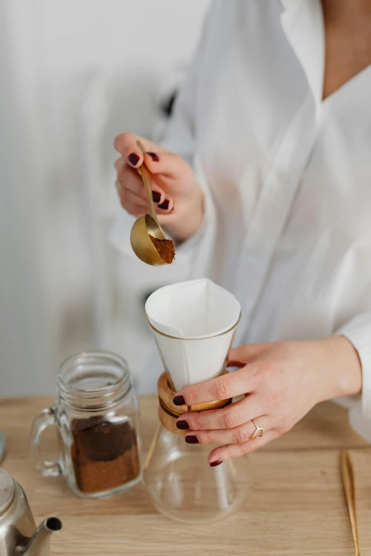 a woman that is making some kind of drink