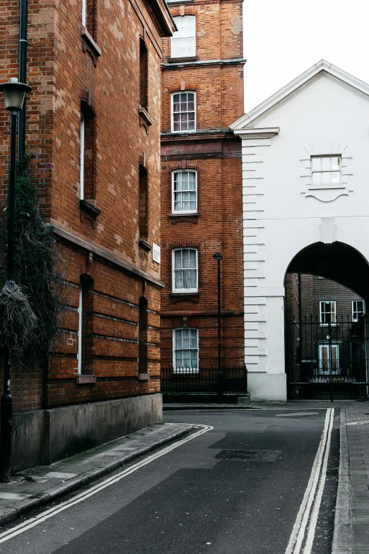 two brick building on the opposite side of an empty street