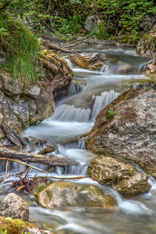 several large rocks have water flowing from them