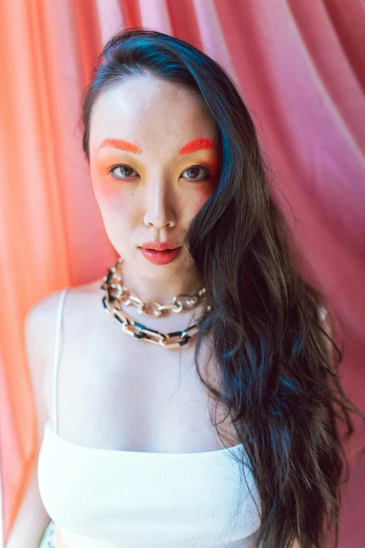 a woman with an orange face paint on her face