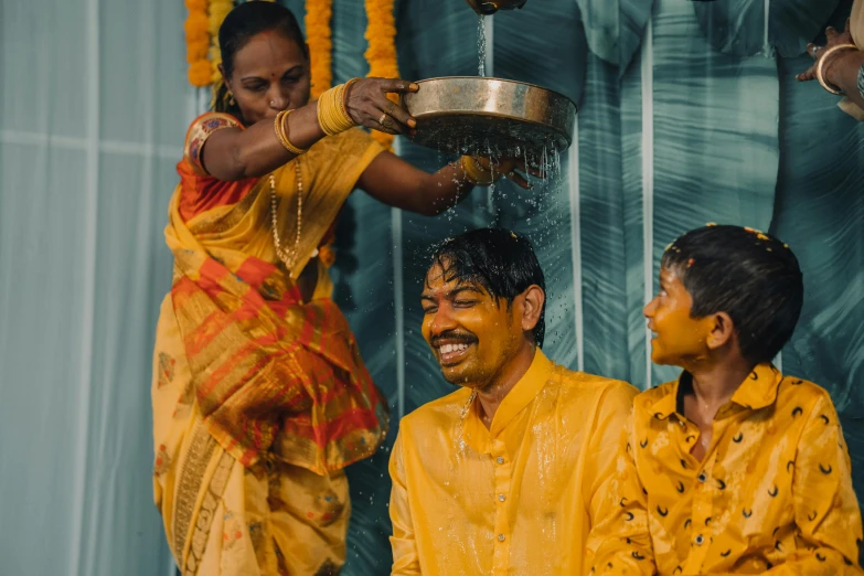 a man and two women are having a shower with water