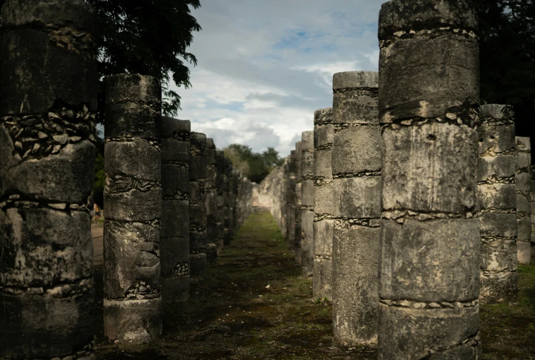 several old stone towers in a line on the grass