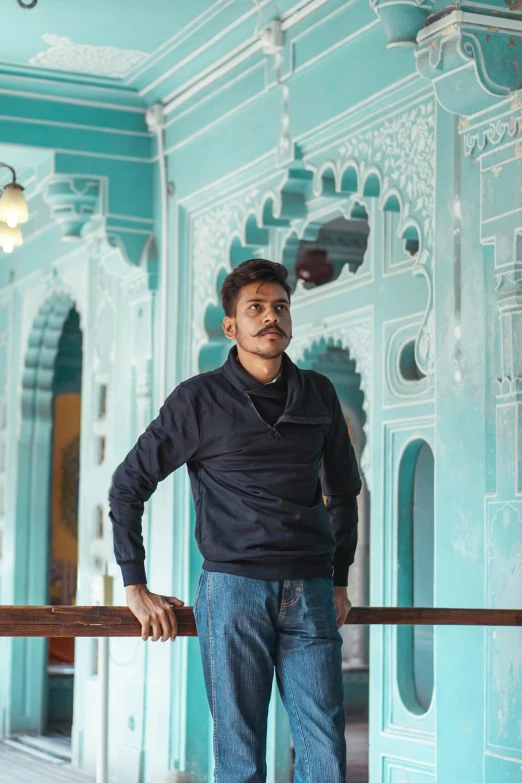 a man stands in an ornate blue building