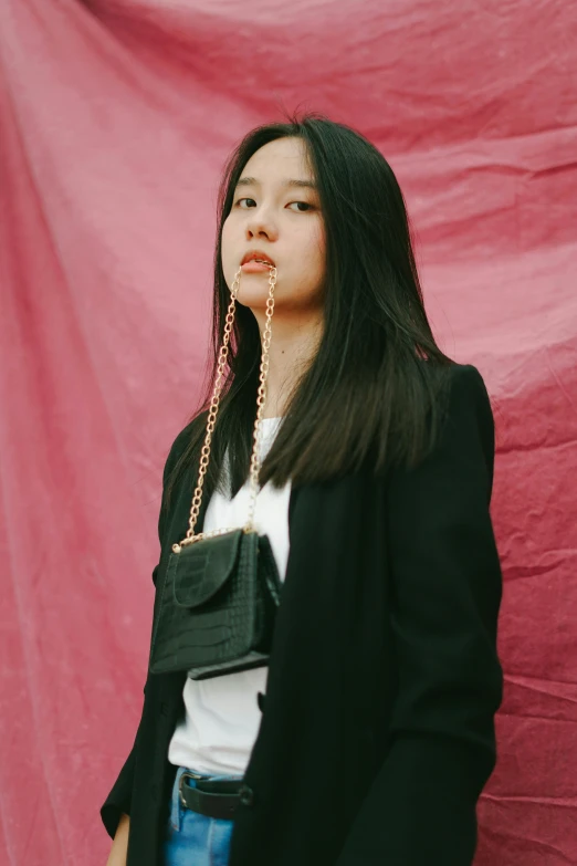 a young woman wearing a pair of gold earrings