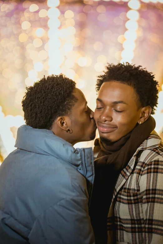 a couple sharing a kiss in front of the fireworks