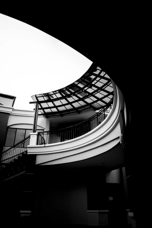 there are curved stairs and balconies that lead into a roof