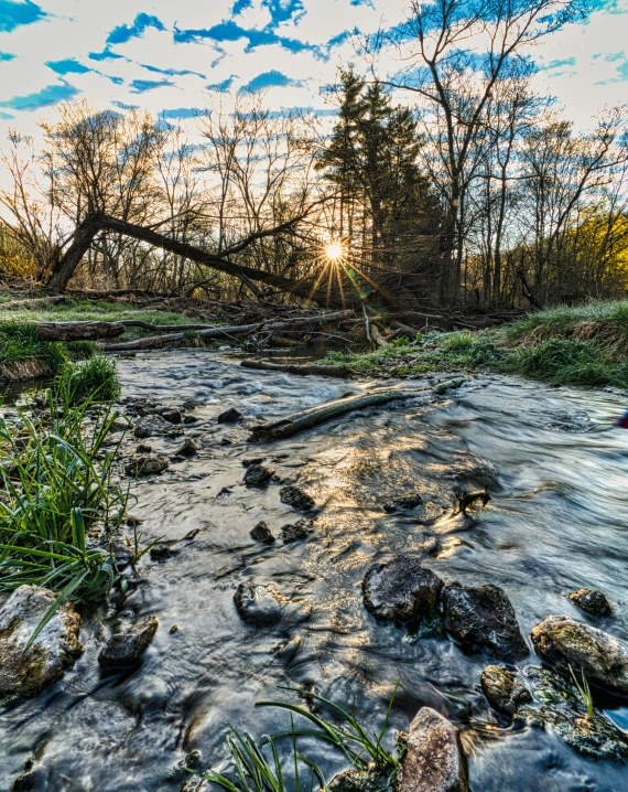 sun shining through the clouds on the water