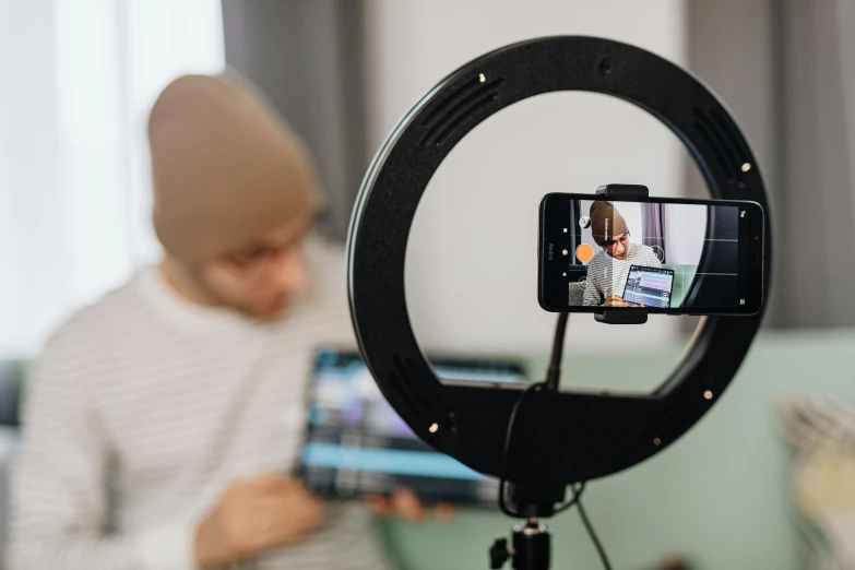 a child sits behind a tablet and recording a video