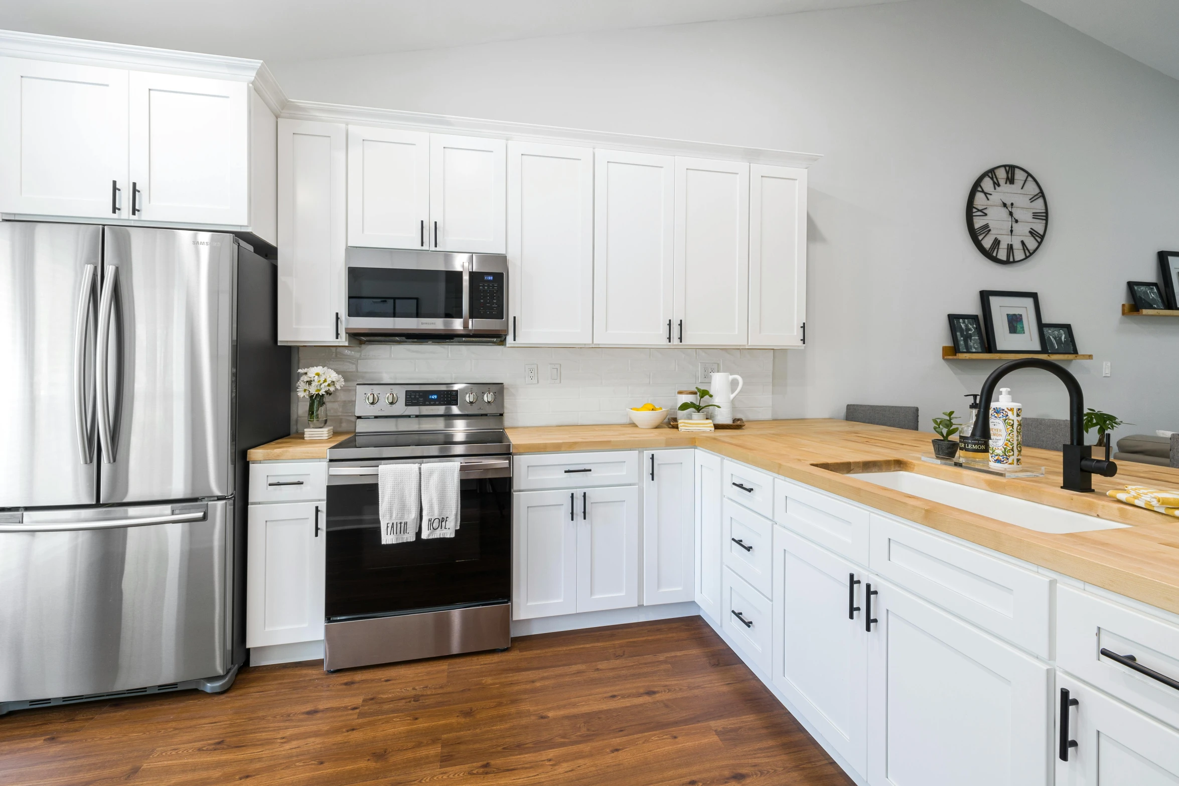 a stainless steel refrigerator and stove in a kitchen