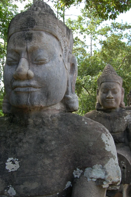 a group of sculptures sitting under a tree