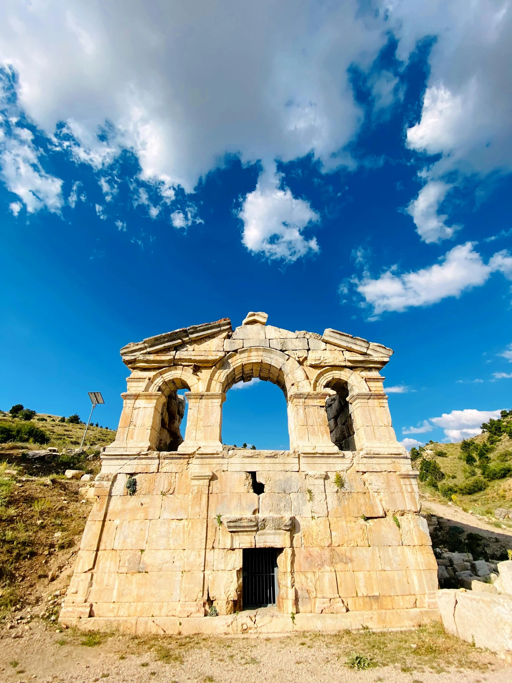 a large ancient structure near a blue sky