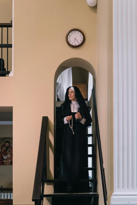 the nun is walking up the stairs