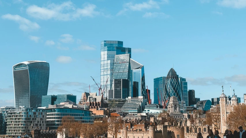 a city skyline with tall buildings and a bridge