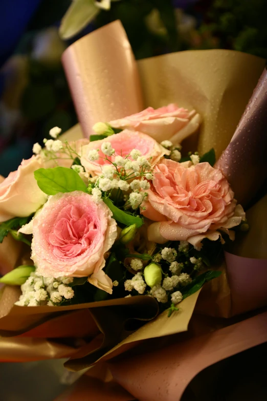 a bouquet with pink roses and babies breath