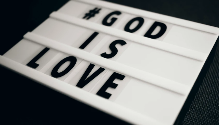the word god is love is spelled with black text