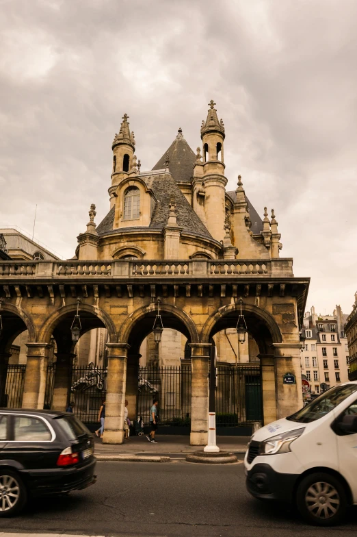 cars in front of an old stone building