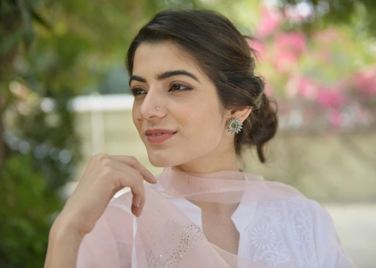 young woman wearing a sheer top, looking into the distance