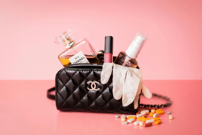 makeup and other personal care items are sitting on a bag