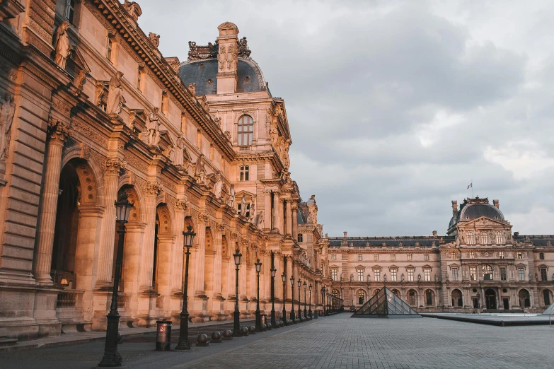 an empty sidewalk leading to some ornate building