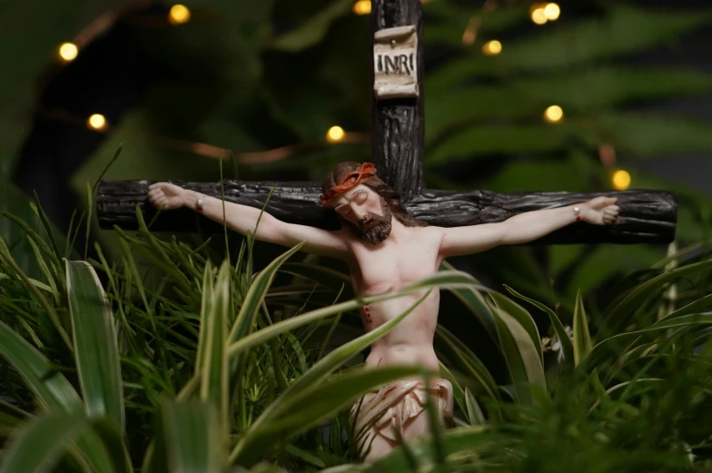 an easter crucifix depicting jesus on a cross with light bulbs around it