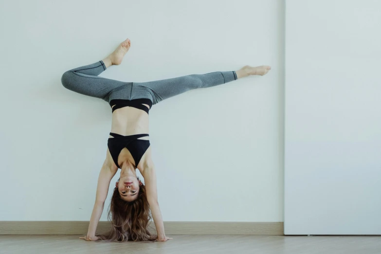 a woman doing a backhand stand in a room