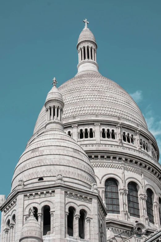 the dome of an old building is shown with a clock