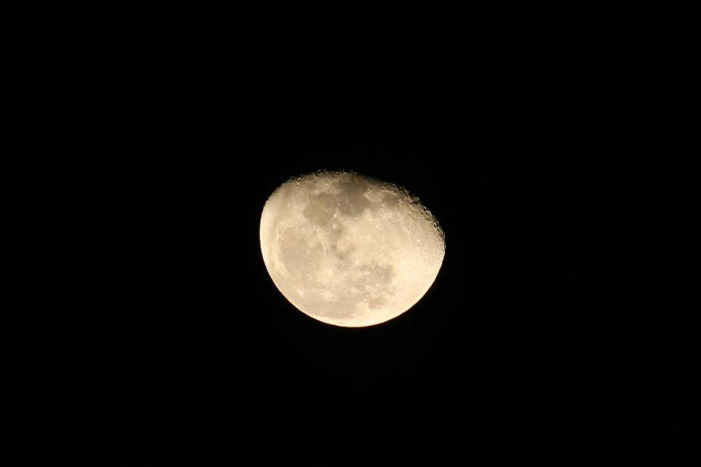 the moon, partially visible through the dark clouds