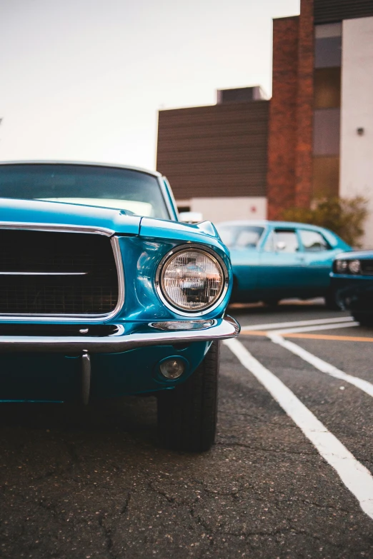 a blue mustang sitting on top of a parking lot