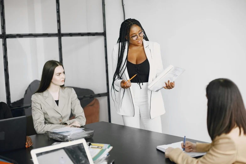 some women at a table with laptops and paperwork