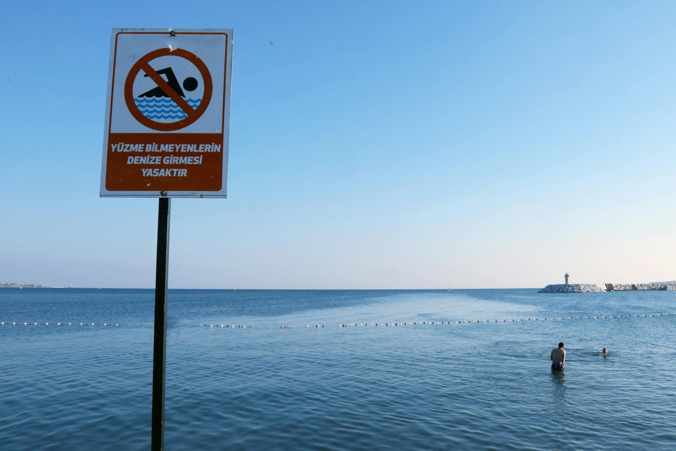 a sign showing where a person is standing in the water