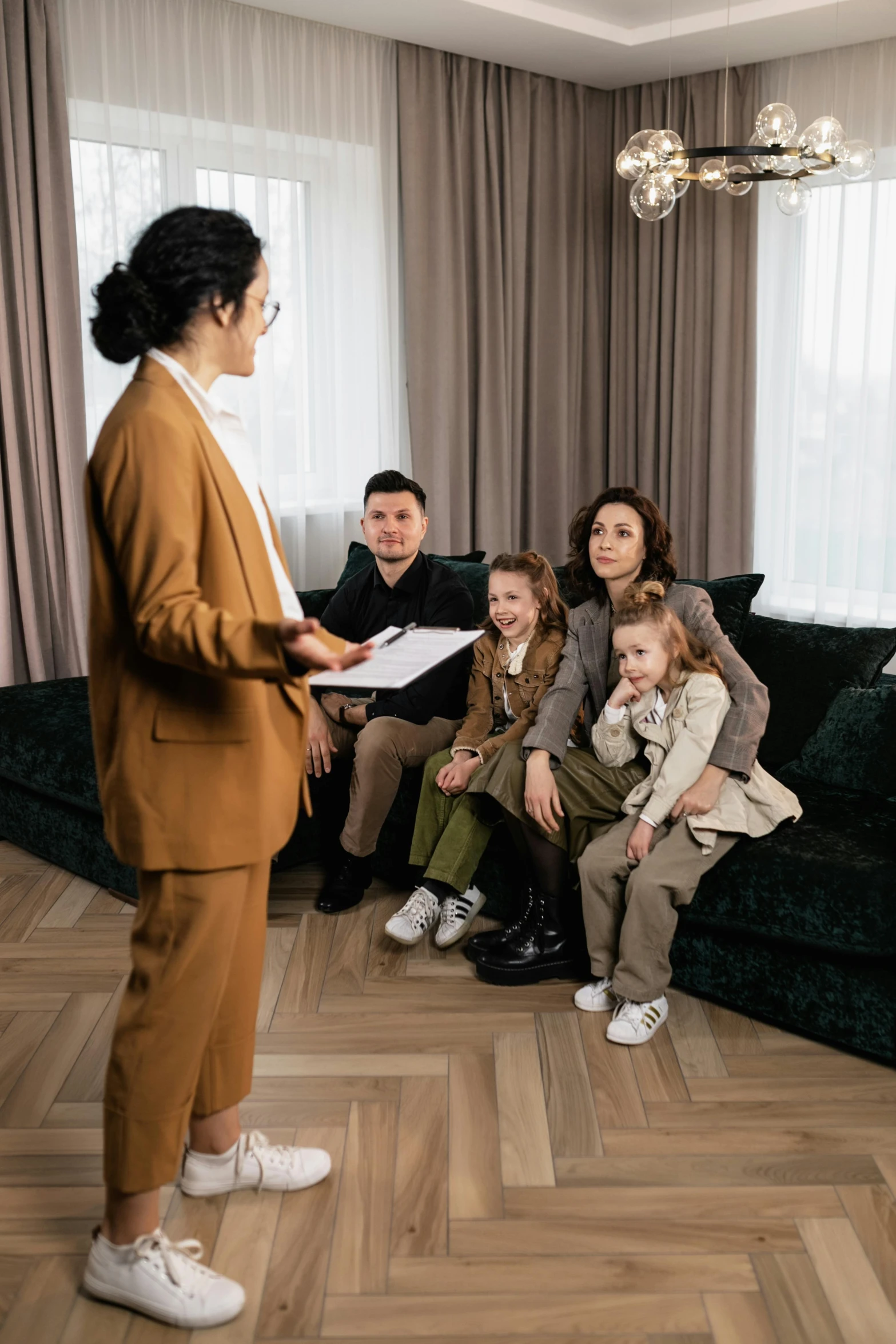 a woman standing with two children and other people