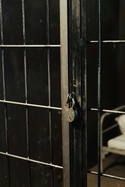 door with lock to prison cell with chair