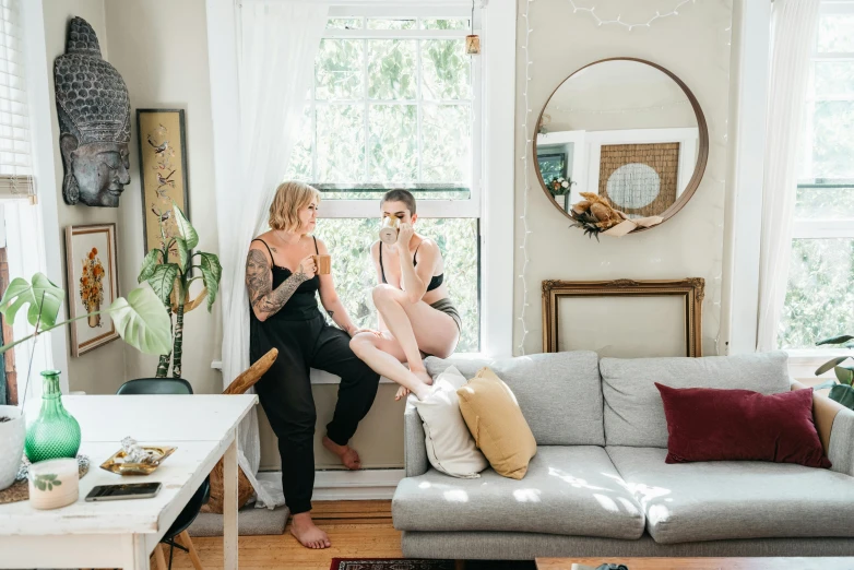 two women sitting on the couch next to each other