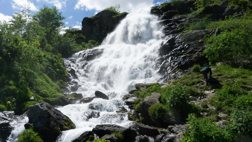 a waterfall is shown surrounded by some rocks