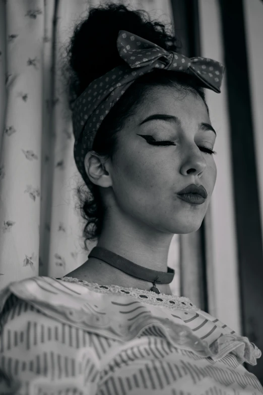 a woman wearing a polka dot head scarf