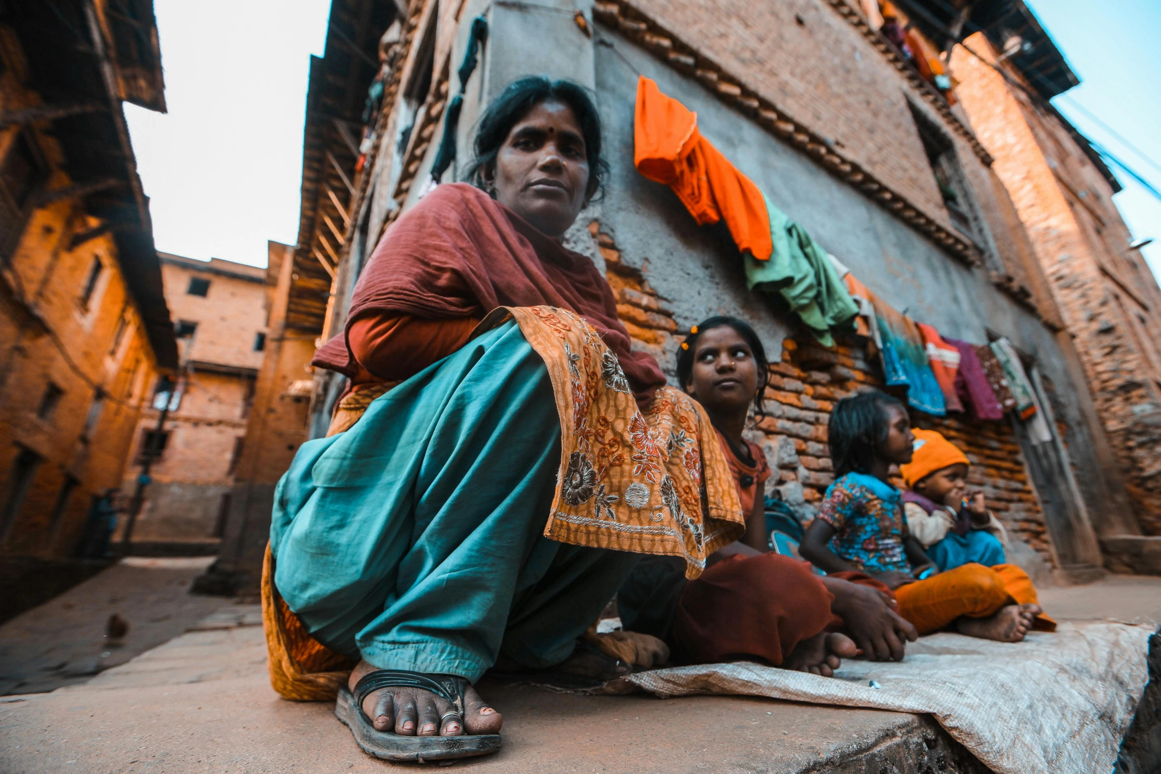 people sitting in the street, talking to a woman