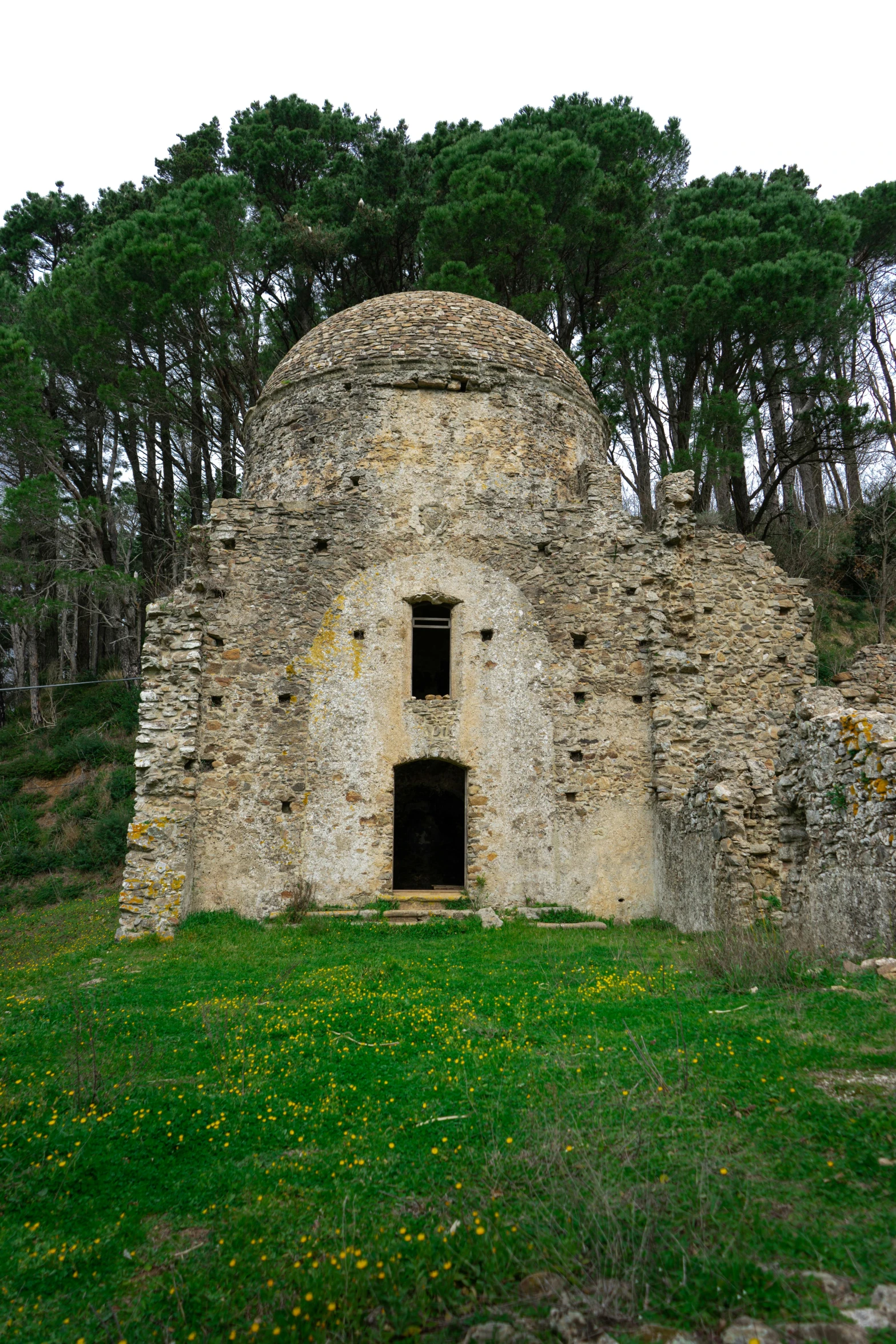 a stone hut with a black door