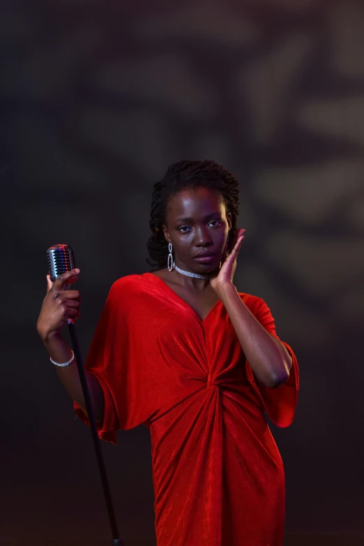 a woman in a red dress is holding a microphone